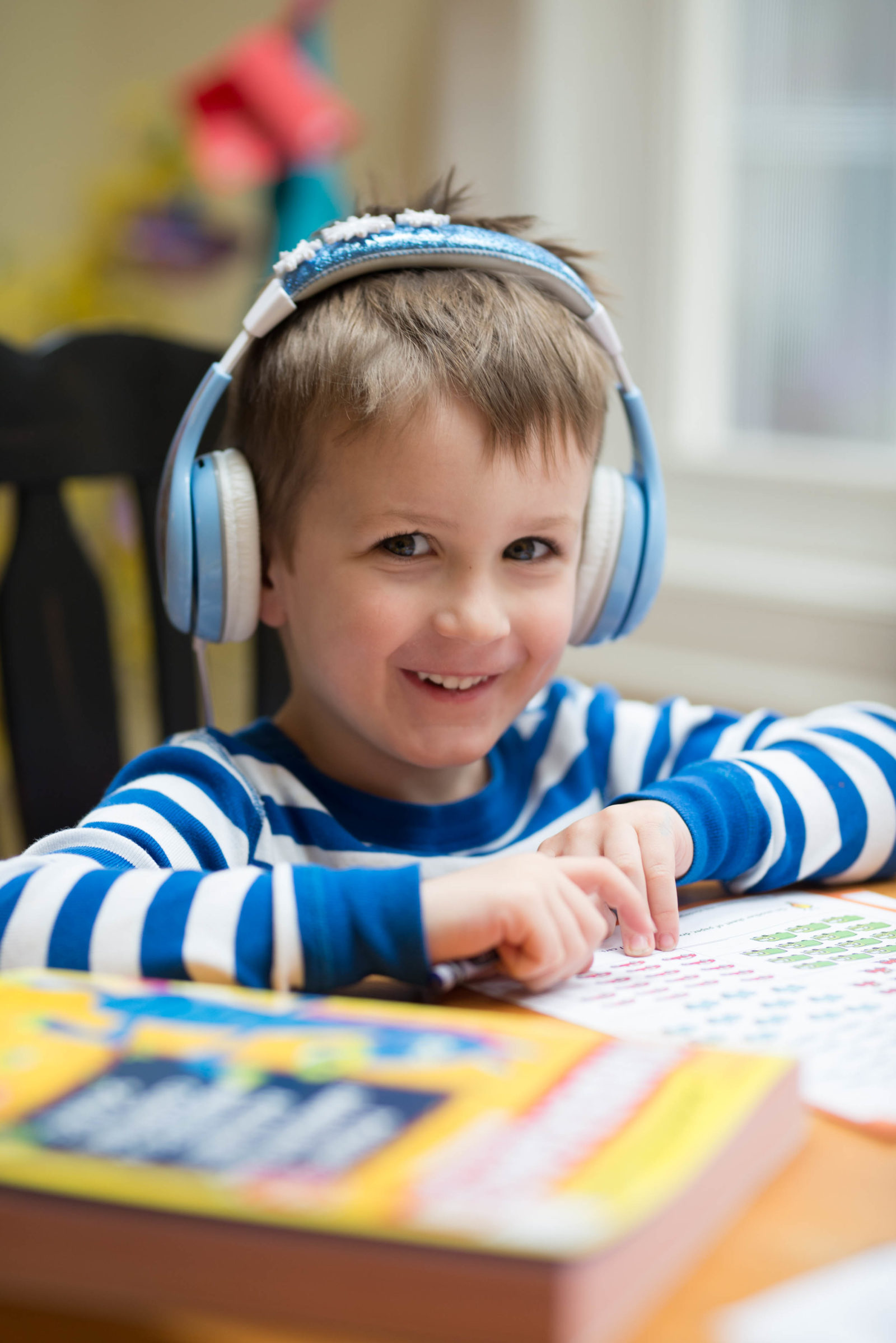 Best toys for 5 year olds from a mom of 4 - boy sitting at the table playing.