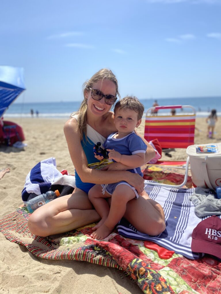 mom wearing her sidestroke swimsuit from summersalt at the beach in 2023