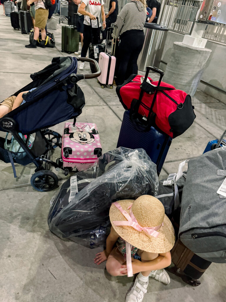 all the luggage at an airport for travel day with best travel stroller