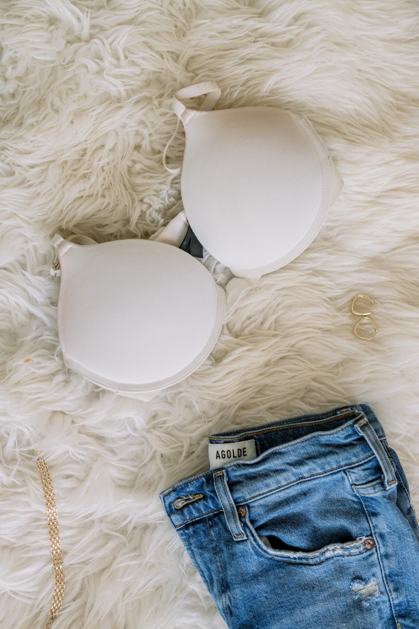 White Pepper Lift Up bra on a rug next to jeans
