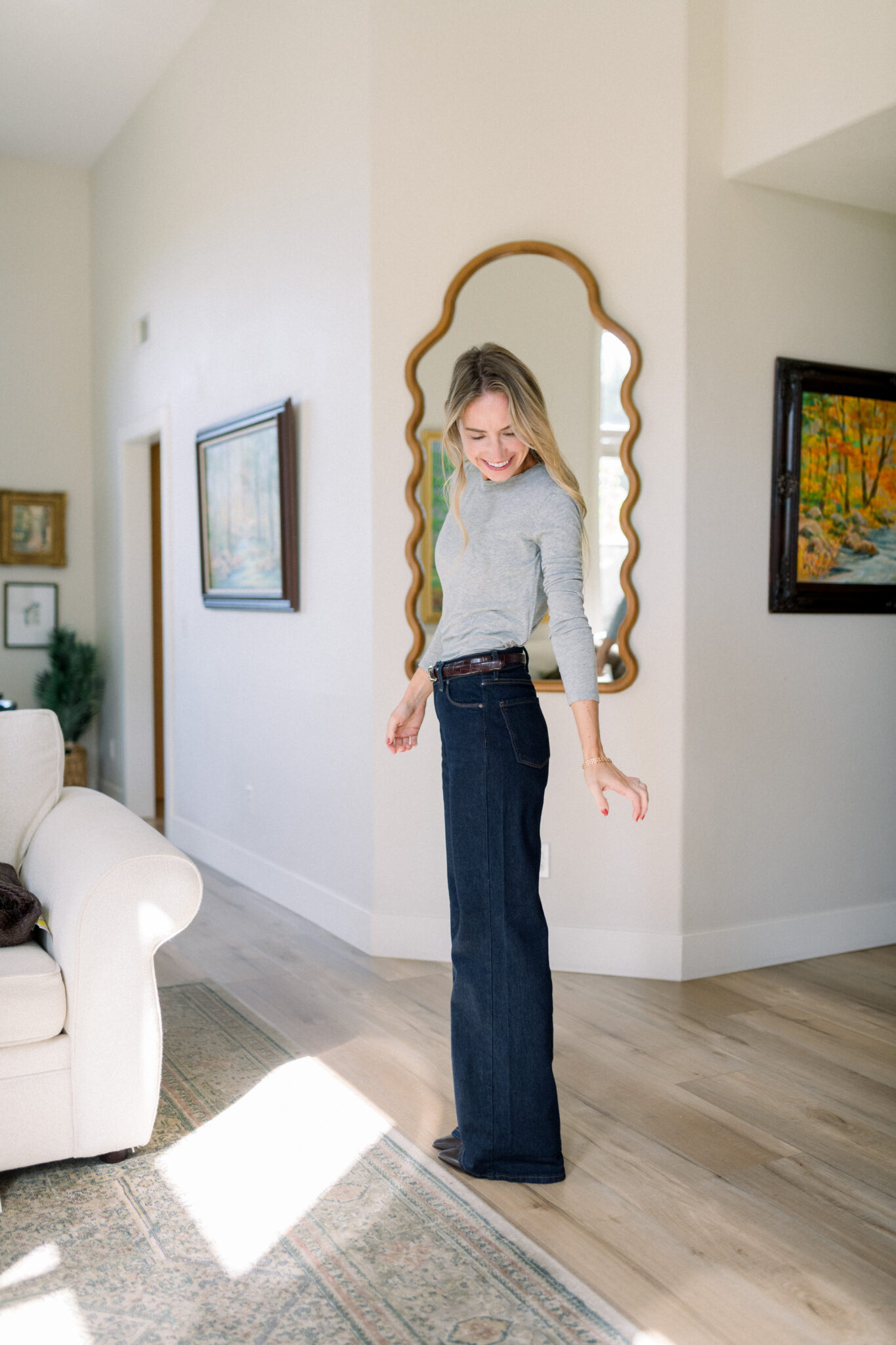 Woman in a fitted gray tee and wide-leg jeans wearing a Pepper bra underneath