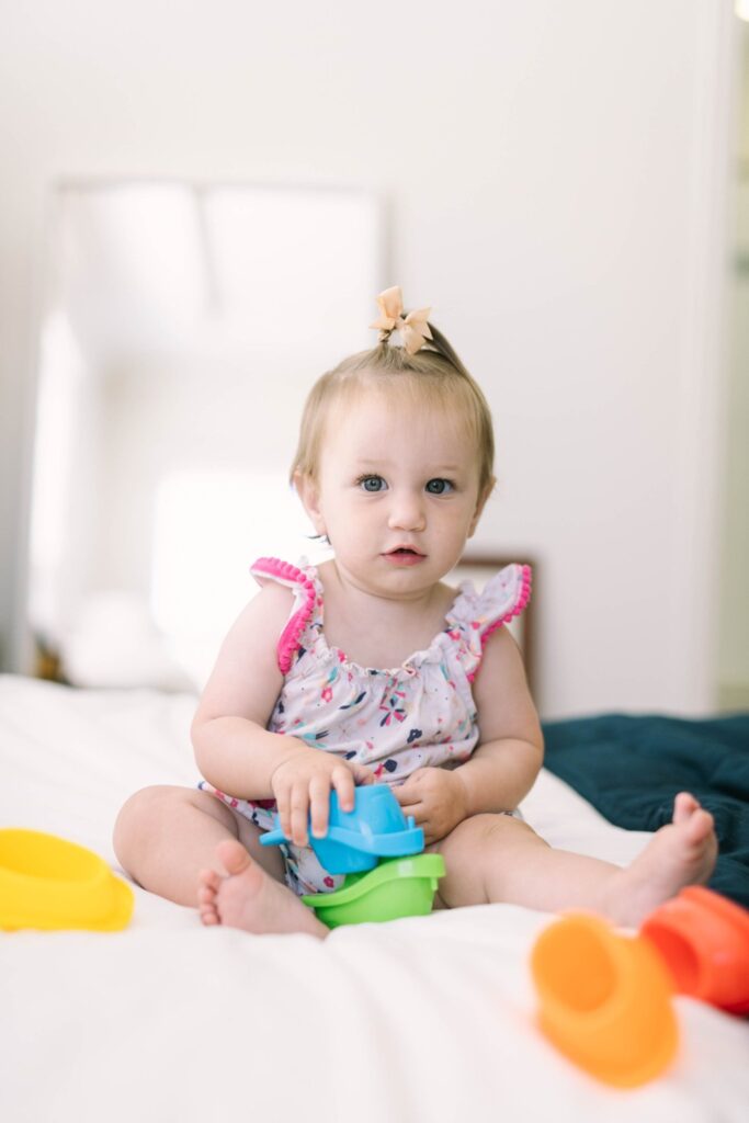 One year old playing with Munchkin bath boats